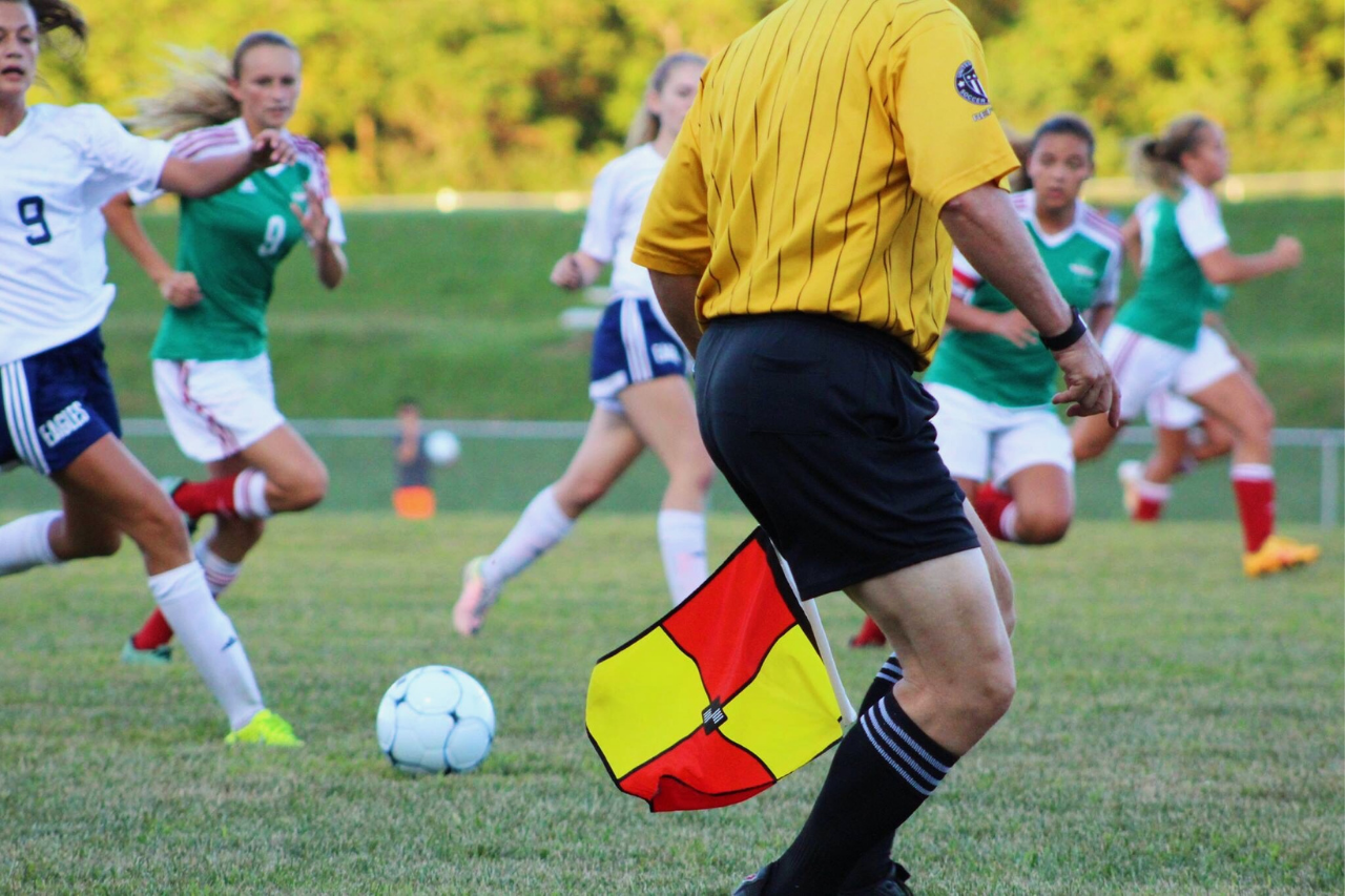 What is the most popular sports league? Picture of football players and referee